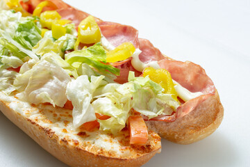 A closeup view of a ham and cheese sub sandwich.