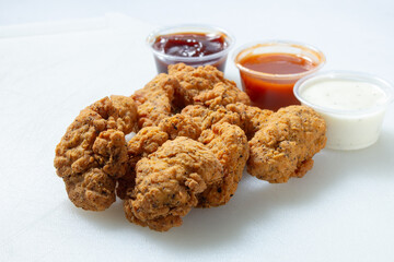 A view of boneless wings and sauces.