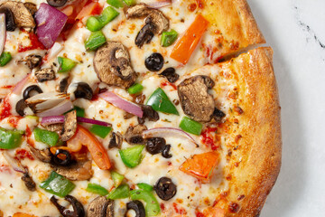 A top down view of a veggie pizza.