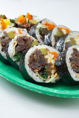 A view of bulgogi kimbap, on a plate.