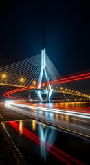 Obraz premium Illuminated Cable-Stayed Bridge Spanning Night Waters with Dynamic Light Trails of Passing Vehicles, Symbolizing Modern Urban Infrastructure and Connectivity