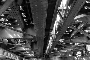 Beautiful interplay of light and shadows under urban steel architecture showcasing intricate...