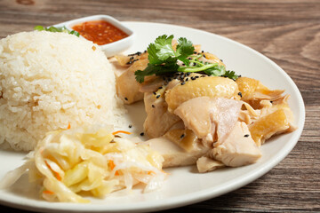 A closeup view of a plate of Hainan chicken.