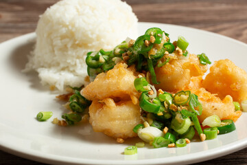 A closeup view of an entree of salt and pepper shrimp.