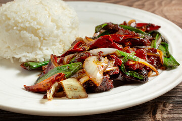 A closeup view of a plate of Mongolian beef.