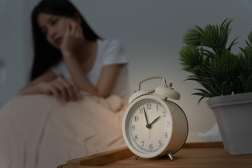 woman in bed late trying to sleep suffering insomnia, sleepless or scared in a nightmare, looking...