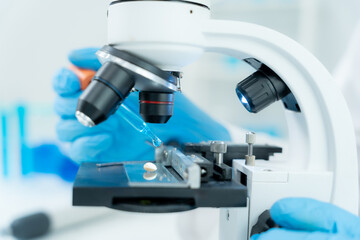 Scientist analyze biochemical samples in advanced scientific laboratory. Medical professional use microscope look microbiological developmental of viral. Biotechnology research in science lab.