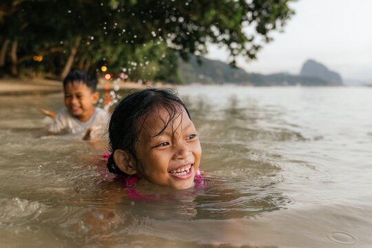 Children enjoying a swim on a Philippine beach