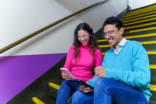 Friends enjoying social media on smartphone and tablet