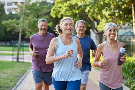 Senior healthy group jogging together at park - Powered by Adobe