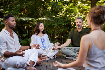 Yoga class meditating in the middle of nature