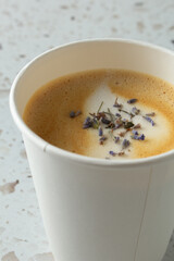 A closeup view of a lavender latte drink.