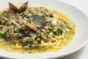 A closeup view of a plate of linguine in clam sauce.