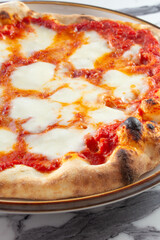 A view of an Italian style cheese pizza.