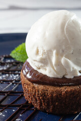 A closeup view of a chocolate torte, a la mode.