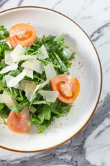 A top down view of an arugula salad.