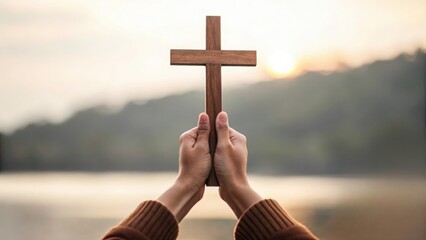 Small wooden cross in center of hands joined together — faith-focused prayer meeting
