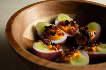 A closeup view of a bowl of deviled eggs.