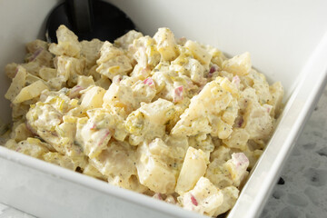 A closeup view of a bowl of potato salad.