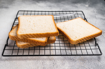 Square Slices of  loaf wheat bread for toasts. white background. top view
