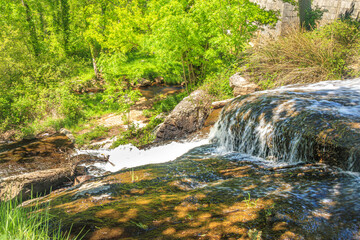 River near Brousse and Villaret in Aude.
Small waterfalls flowing among rocks and undergrowth in...