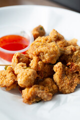 A closeup view of a bowl of popcorn chicken.