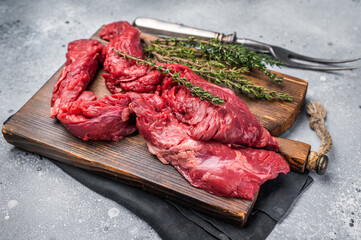 Uncooked Beef Skirt Steak, also name Machete steak, raw meat on cutting board. grey background. top view