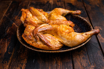 Baked chicken Tabaka Tobacco with spices, poultry meat on plate. wooden background. top view