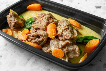 A view of a meal prep entree featuring slow cooked beef and polenta.