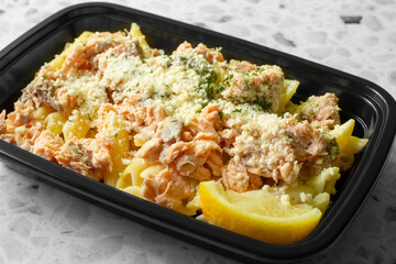 A view of a salmon and pasta meal prep entree.