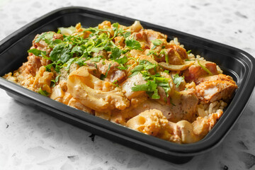 A view of a meal prep container of chicken tikka masala.