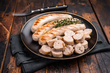 Grilled Sausages with forcemeat mincemeat and herbs in plate. wooden background. top view