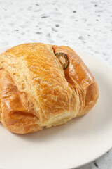 A closeup view of a jalapeno ham and cheese croissant.