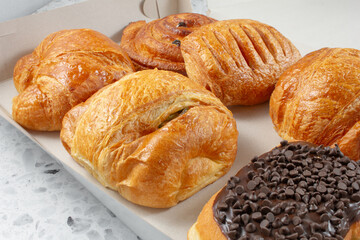 A view of a box of assorted breakfast pastries.