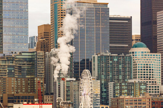 Seattle city, the downtown area, smoke issuing from buildings, a ferris wheel ride