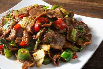 A closeup view of a plate of spicy stir fried beef.