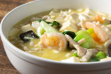 A closeup view of a tofu shrimp soup.