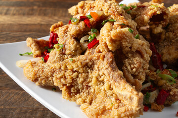 A closeup view of a plate of salt and pepper fish.