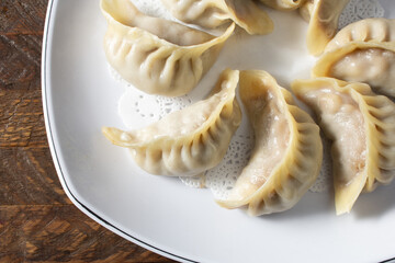 A top down view of a plate of steamed dumplings.