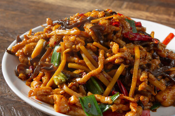 A closeup view of a plate of shredded pork with garlic sauce.