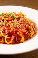 A view of a bowl of linguine in marinara sauce.