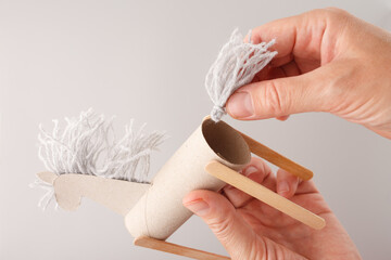 DIY moment hands assembling homemade toy horse using simple materials. cardboard tube, Wooden...