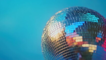 Brightly lit, spinning metallic disco ball with colorful reflective facets. - Powered by Adobe