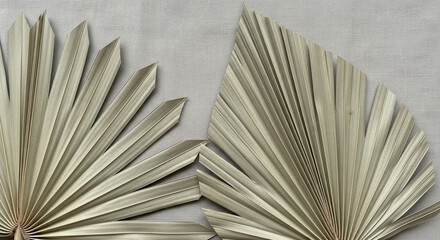 Minimalist composition with two dried palm leaves on neutral fabric background elegant botanical decor trend with natural beige tones and textured geometric shapes