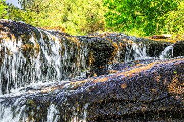 River near Brousse and Villaret in Aude.
Small waterfalls flowing among rocks and undergrowth in...