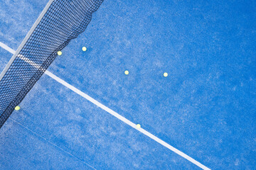 top down aerial drone video footage on a blue paddle tennis court, racket sports courts concept