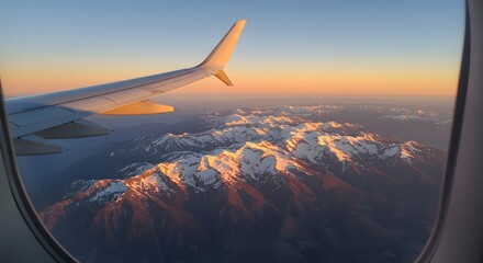 Obraz premium Scenic View of Mountain Sunrise from Airplane Wing