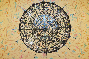 Antique chandelier on the ceiling with painting