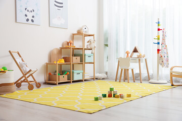 Stylish playroom with toys and furniture. Interior design