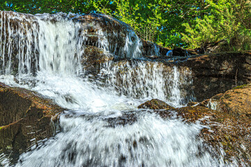 River near Brousse and Villaret in Aude.
Small waterfalls flowing among rocks and undergrowth in...